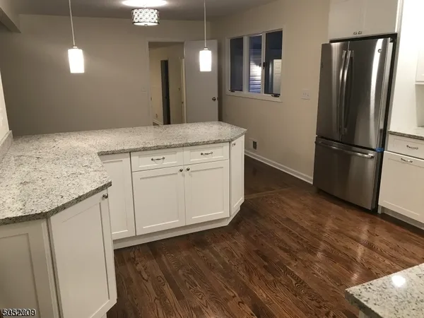 a view of a kitchen counter space and wooden floor