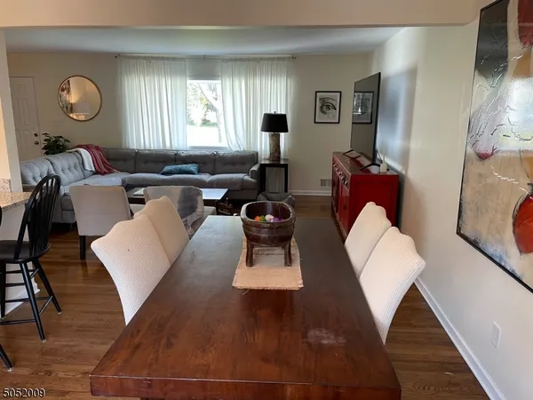 a living room with lots of furniture and a large window