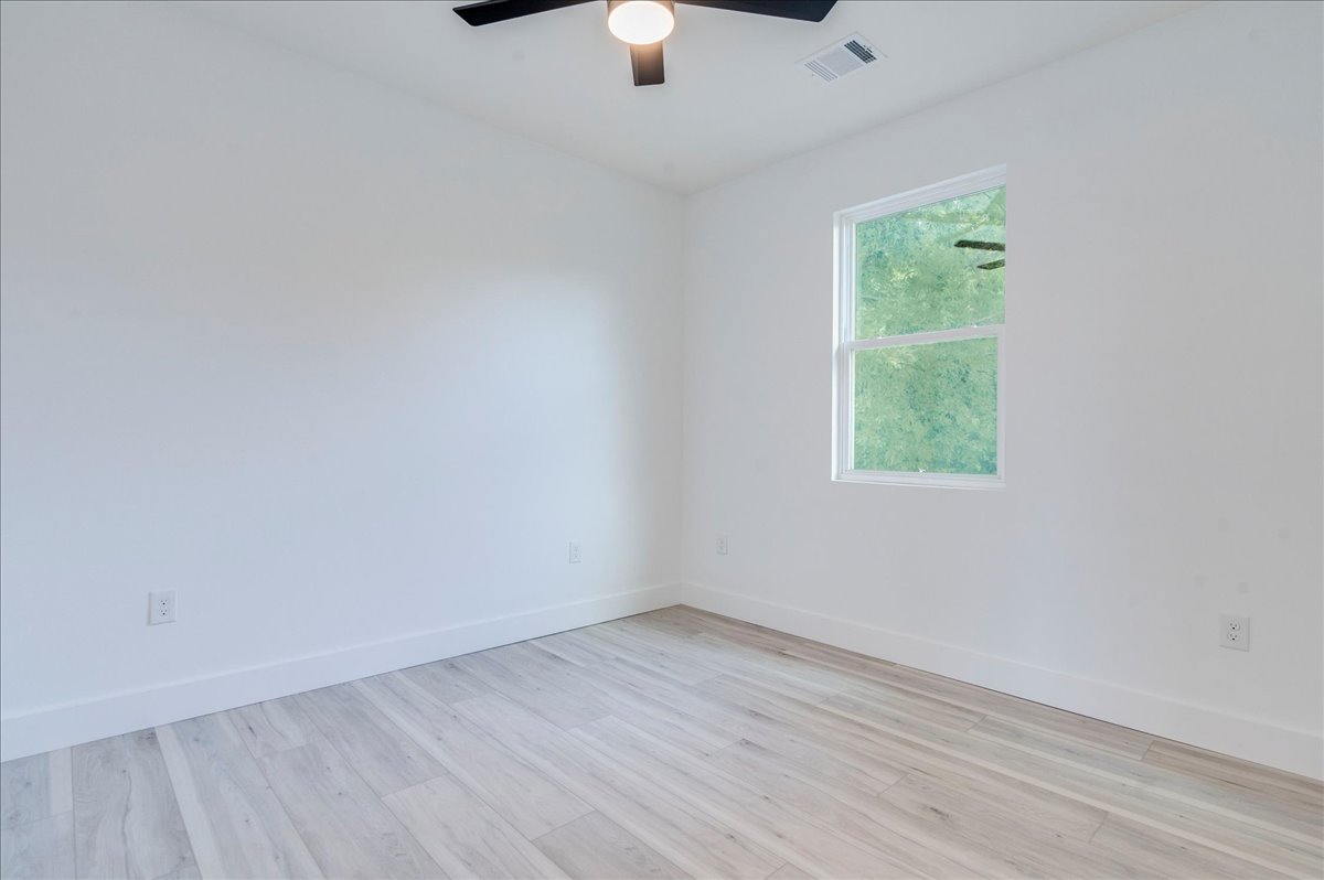 1215 Howard Street Taylor, TX 76574 - Photo 30 of 37 Room featuring wood finished floors and ceiling fan