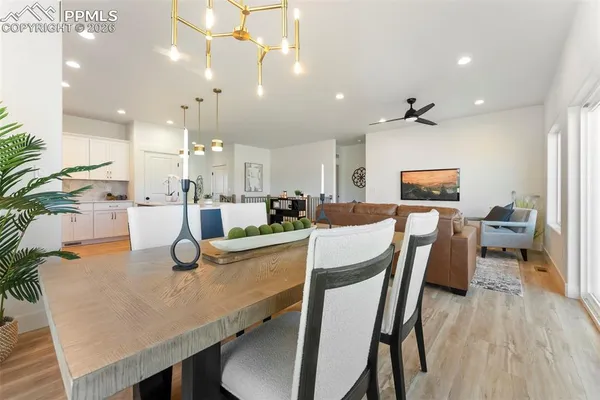 a dining room with furniture and wooden floor