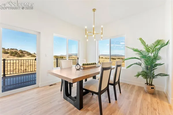 a view of a dining room with furniture window and wooden floor
