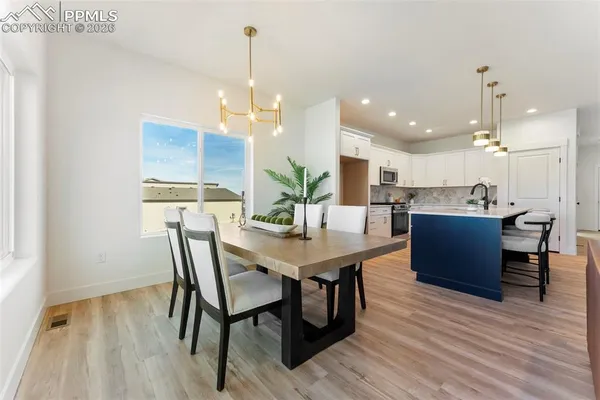 a view of a dining room with furniture and wooden floor
