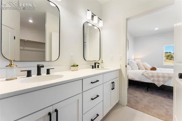 a en suite bathroom with double sink and a mirror