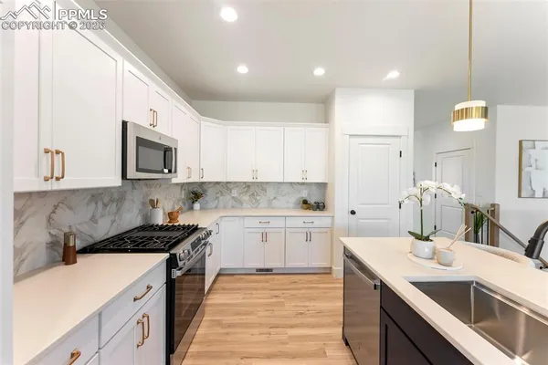 a kitchen with a sink stove and microwave