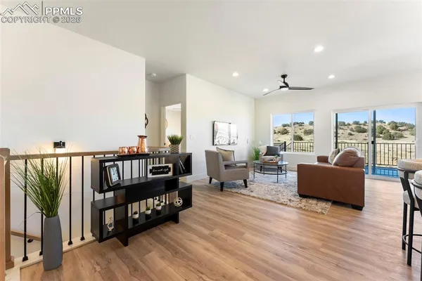 a living room with furniture window and wooden floor