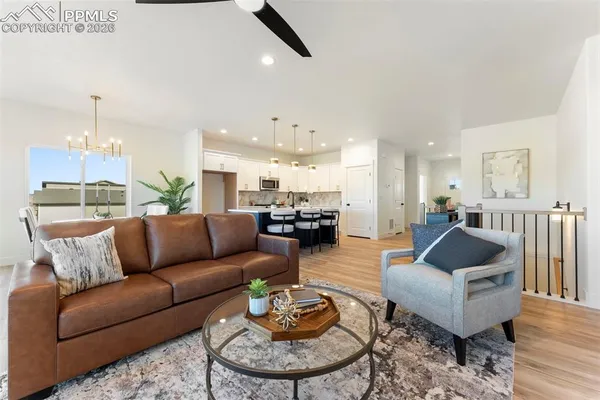 a living room with furniture and a view of kitchen