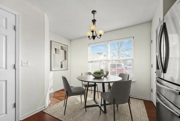 a dining room with furniture a chandelier and wooden floor