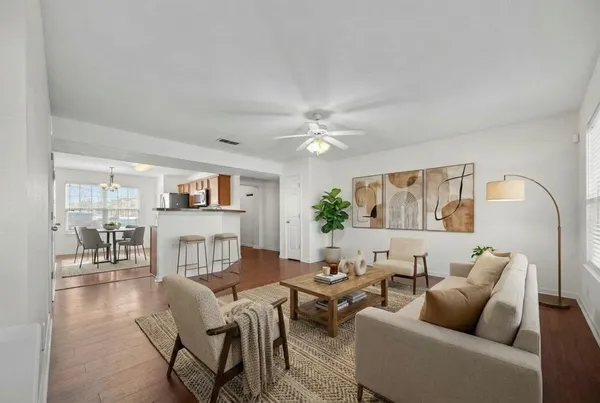 a living room with furniture and a chandelier