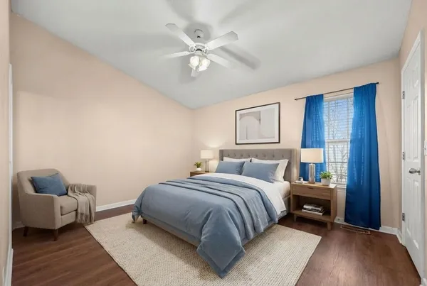 a bedroom with a bed and wooden floor