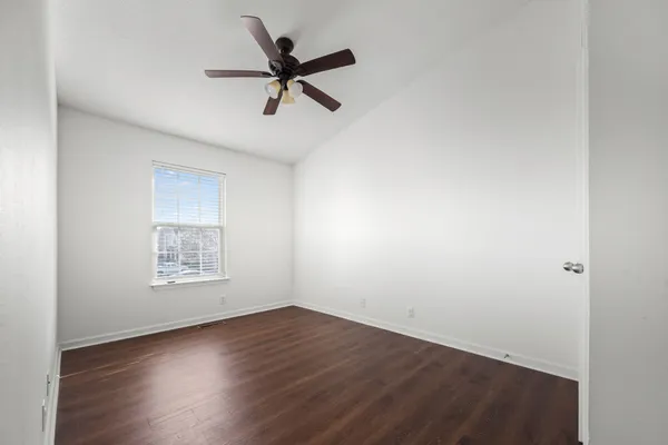 a view of a room with wooden floor and windows