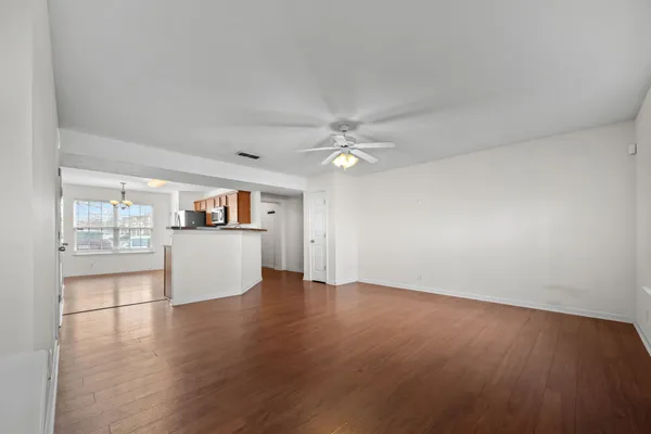 a view of a kitchen with wooden floor and a kitchen view