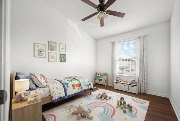 a bedroom with a bed and a window