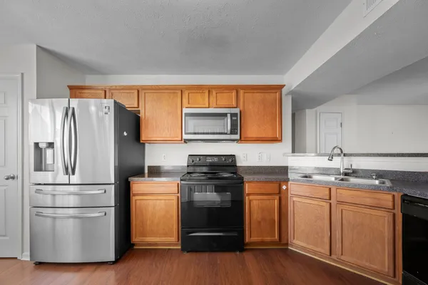 a kitchen with a refrigerator stove and sink