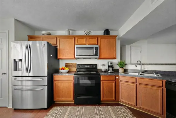 a kitchen with stainless steel appliances a refrigerator stove and sink