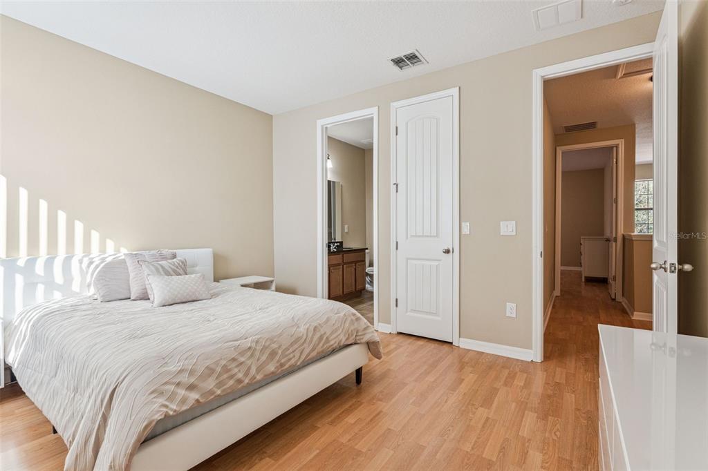 13232 Longacre Drive Windermere, FL 34786 - Photo 19 of 28 a bedroom with a bed and a table