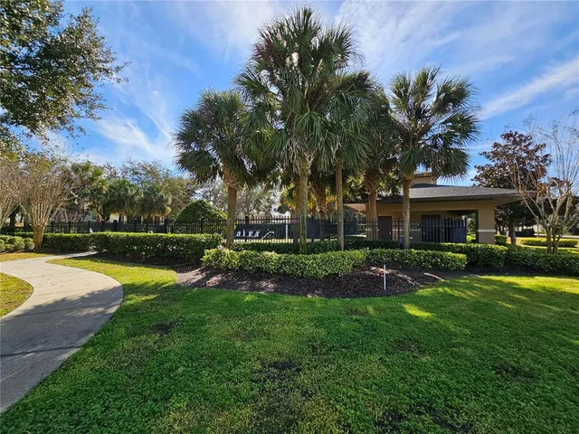 a view of a house with swimming pool and yard with green space