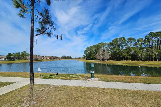 a view of a lake with a house in the background
