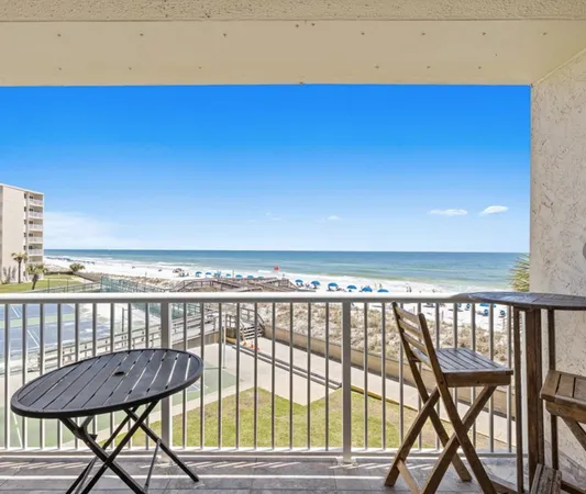 a view of a balcony with furniture and wooden floor