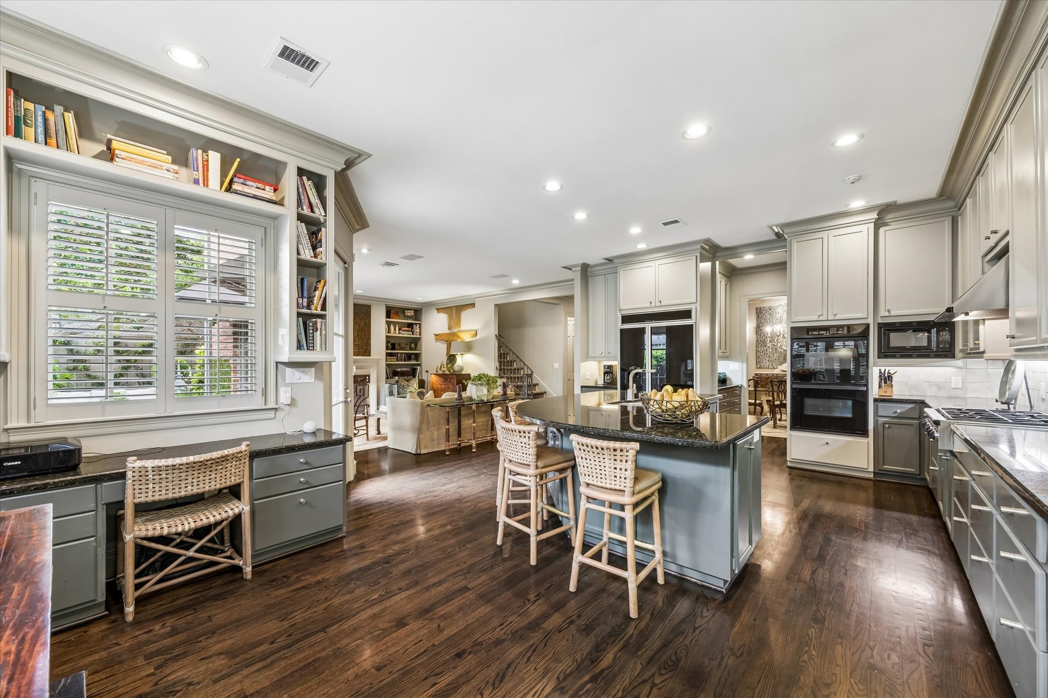 2627 Sutton Court Houston, TX 77027 - Photo 11 of 34 Another view of the kitchen highlighting the double wall ovens and offering a peek into the butler’s pantry.