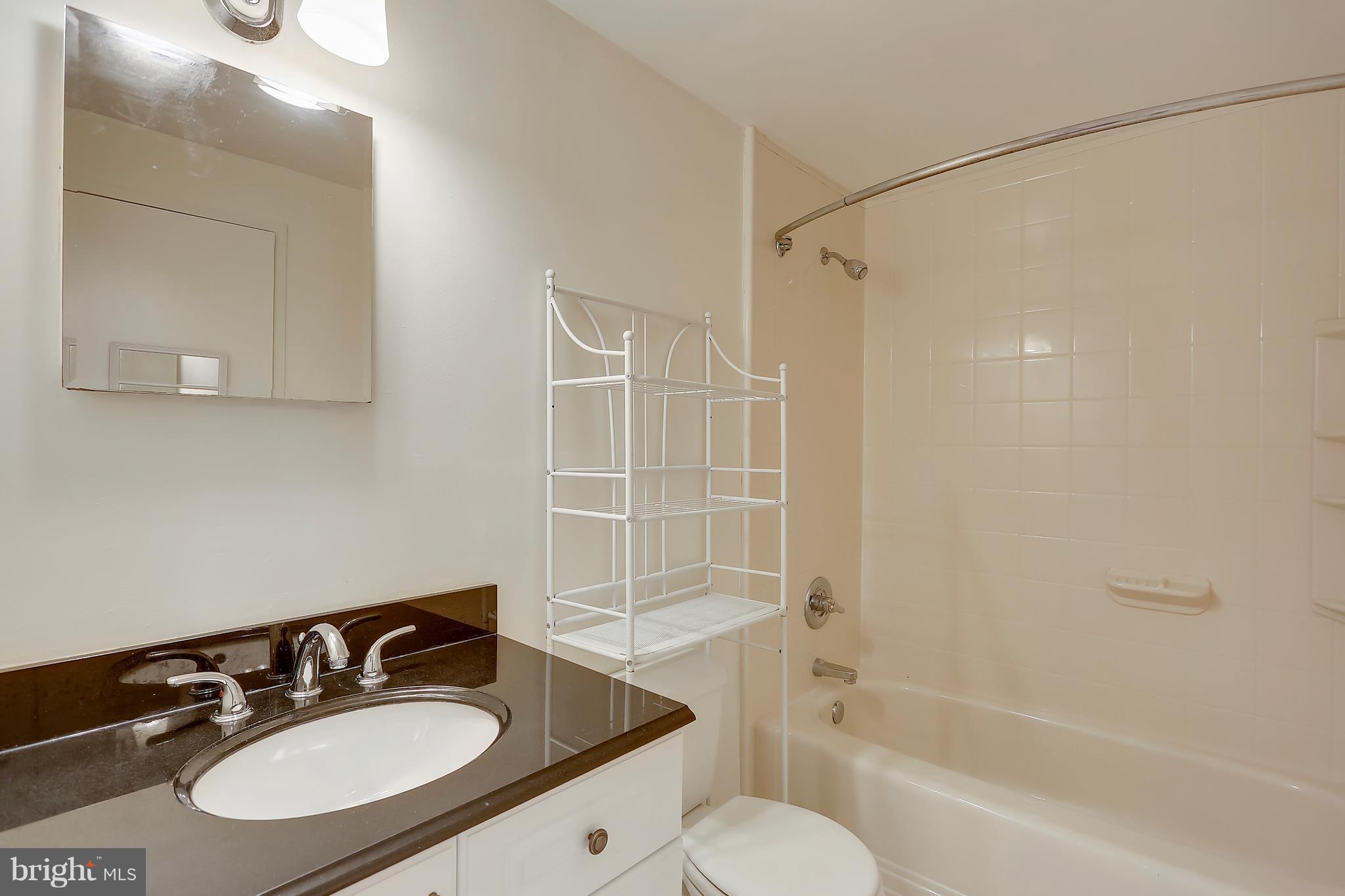 10740 Lester Street Silver Spring, MD 20902 - Photo 16 of 30 a bathroom with a sink toilet tub and shower