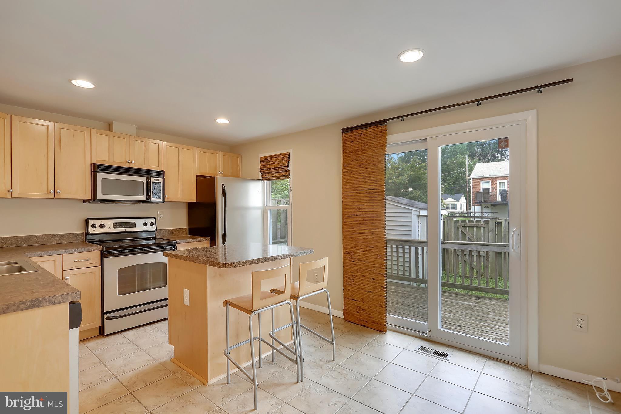 10740 Lester Street Silver Spring, MD 20902 - Photo 5 of 30 a kitchen with stainless steel appliances a stove a sink refrigerator and microwave