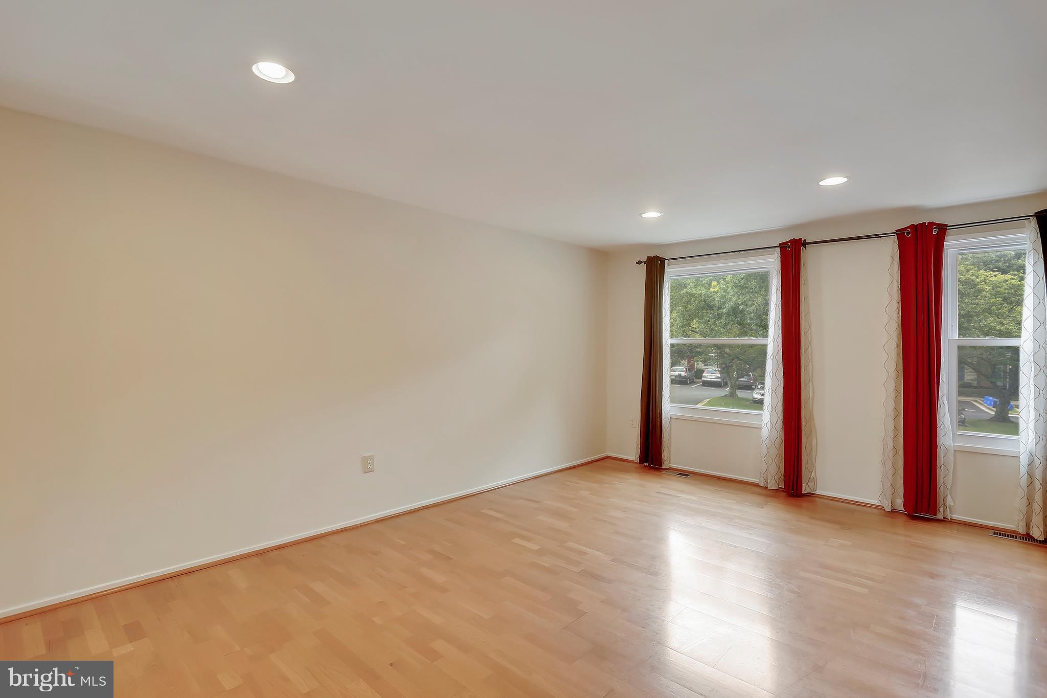 10740 Lester Street Silver Spring, MD 20902 - Photo 8 of 30 a view of an empty room with wooden floor and a window