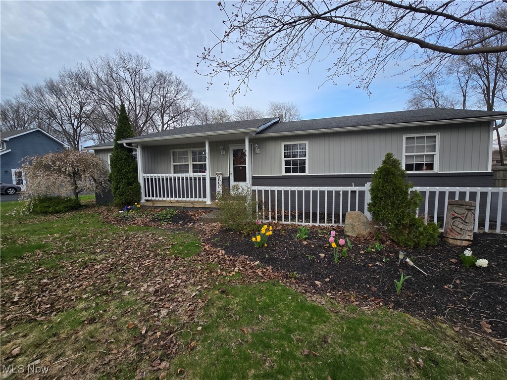 View of front of property with fence and a porch
