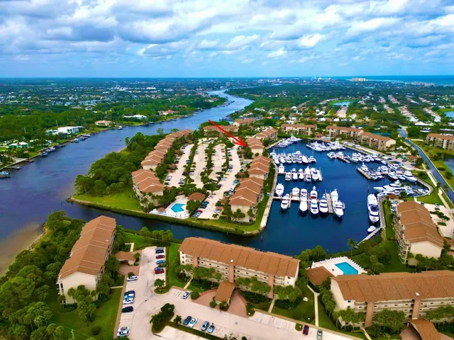 an aerial view of residential houses with outdoor space and ocean view