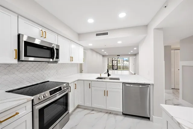 a kitchen with a sink stove and microwave