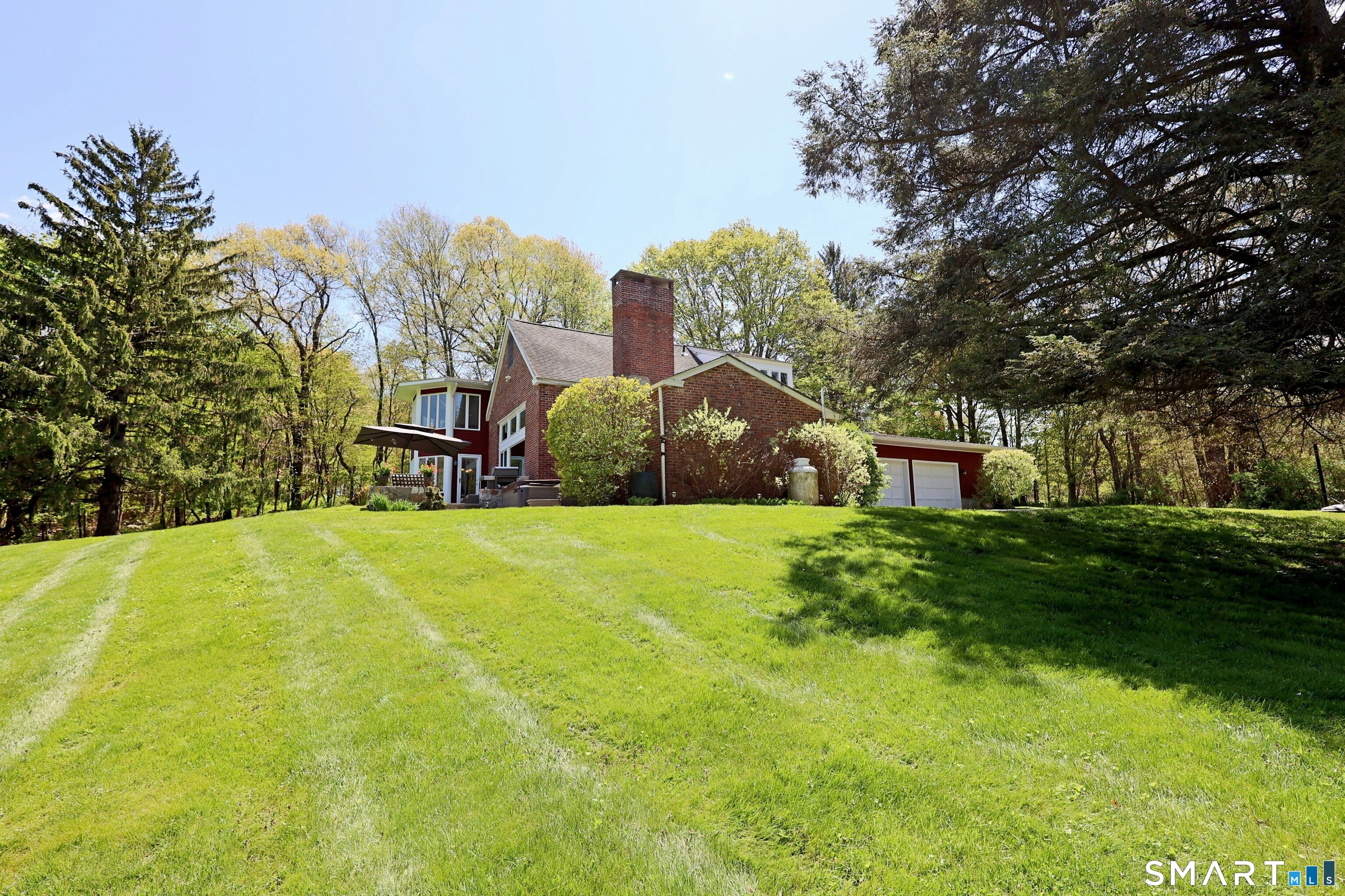 68 Bloomer Road Ridgefield, CT 06877 - Photo 8 of 40 a view of a big yard with large trees and a small barn