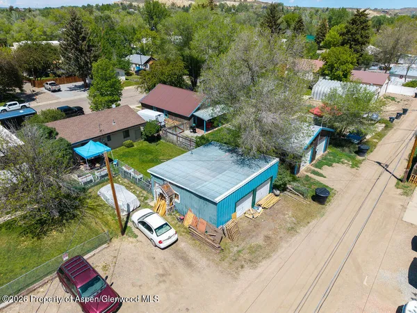 an aerial view of multiple houses with yard