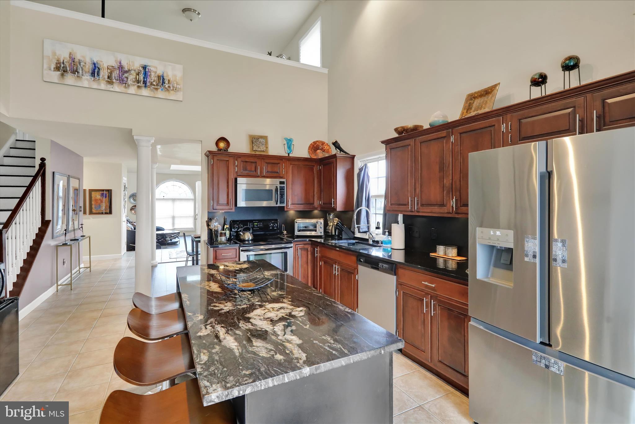 73 Michigan Drive Reading, PA 19608 - Photo 17 of 42 a kitchen with stainless steel appliances granite countertop a refrigerator a stove and a sink with wooden floor