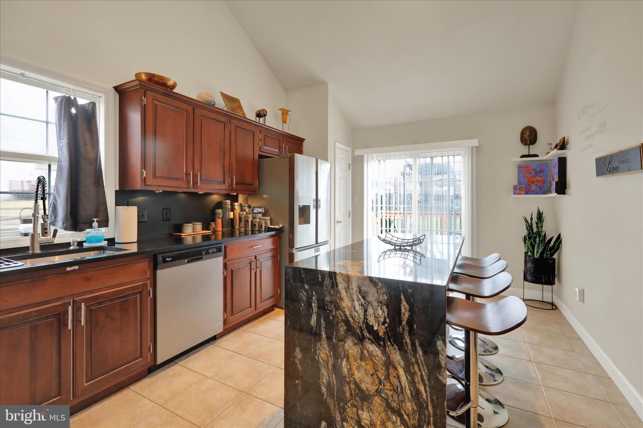 73 Michigan Drive Reading, PA 19608 - Photo 19 of 42 a kitchen with stainless steel appliances kitchen island granite countertop a table chairs in it and a window