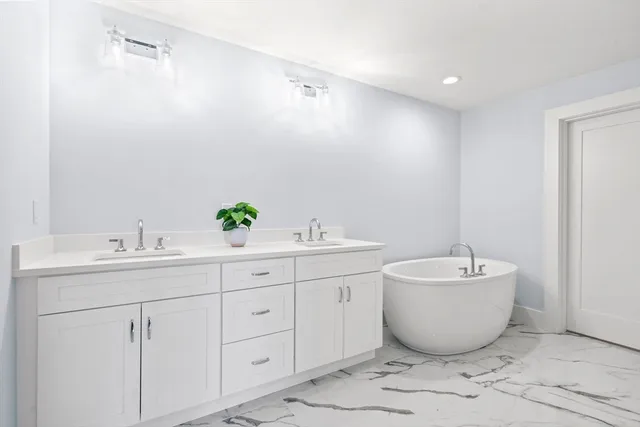 a spacious bathroom with a bathtub and sink