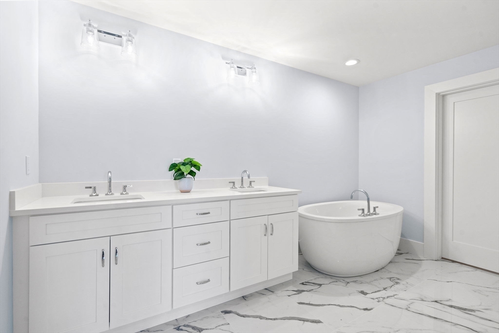 1060 Grove Street, Unit LOT 23 Framingham, MA 01701 - Photo 14 of 15 a spacious bathroom with a bathtub and sink