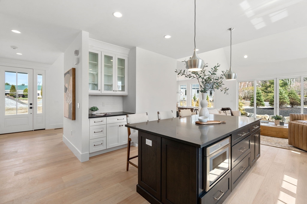 1060 Grove Street, Unit LOT 23 Framingham, MA 01701 - Photo 3 of 15 a kitchen island with appliances and cabinets