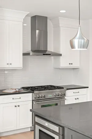 a kitchen with granite countertop a stove and a sink