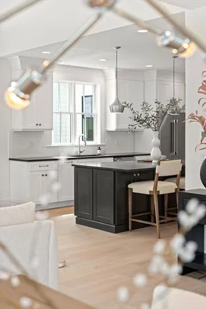 a kitchen with a sink cabinets and window