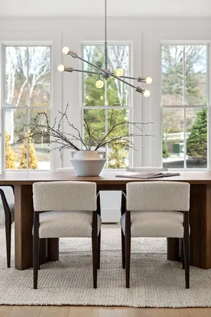 a living room with a table and a potted plant