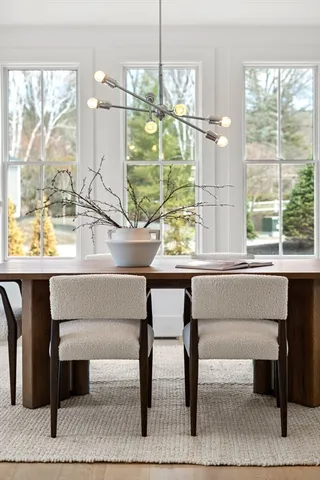 a living room with a table and a potted plant
