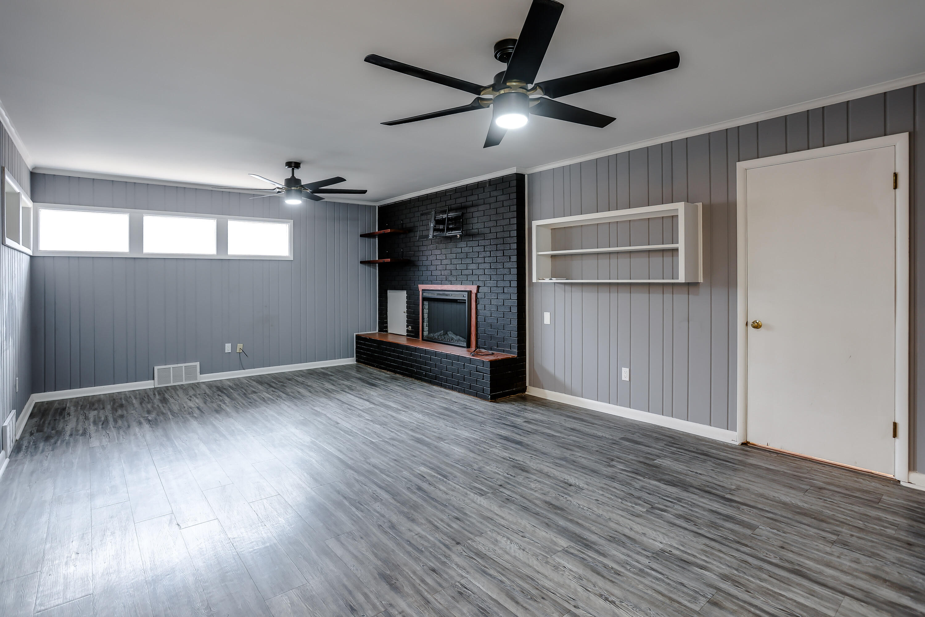 3615 47th Street Lubbock, TX 79413 - Photo 9 of 36 wooden floor in an empty room with a window