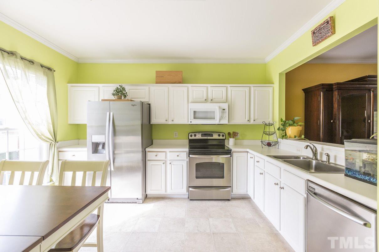 5524 Red Robin Road Raleigh, NC 27613 - Photo 8 of 24 a kitchen with a refrigerator sink and stove top oven