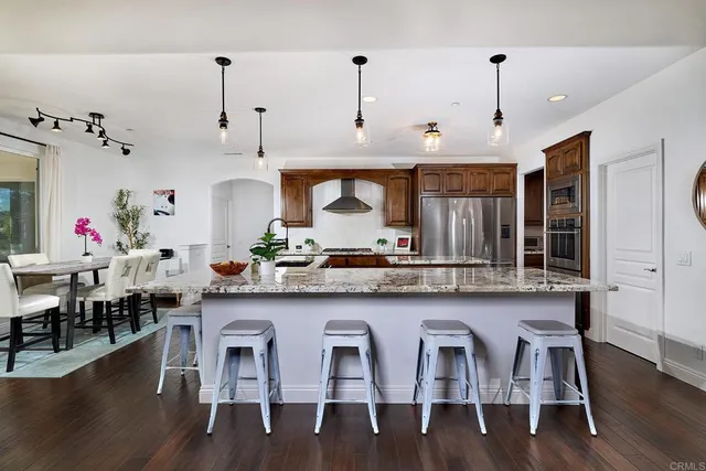 a view of a dining room with furniture wooden floor and a chandelier