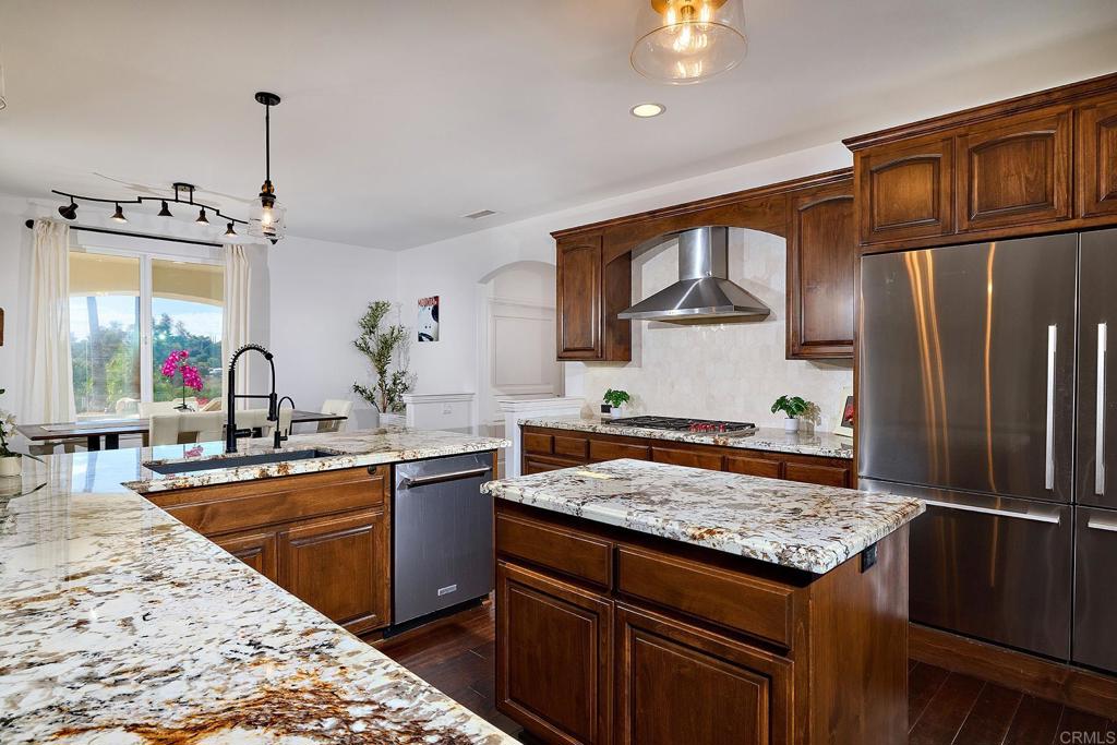 2869 Dos Lomas Place Fallbrook, CA 92028 - Photo 20 of 55 a kitchen with stainless steel appliances granite countertop a sink stove and refrigerator