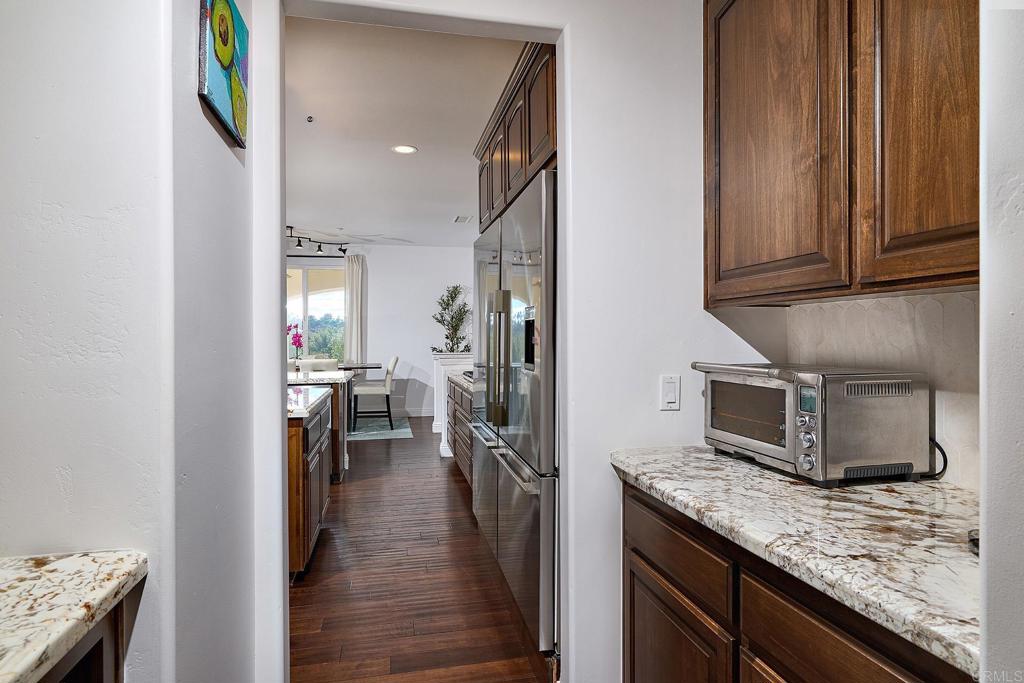 2869 Dos Lomas Place Fallbrook, CA 92028 - Photo 21 of 55 a kitchen with stainless steel appliances granite countertop a refrigerator and microwave