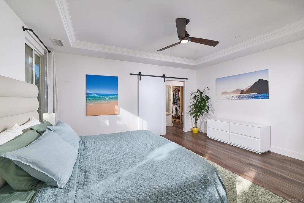 2869 Dos Lomas Place Fallbrook, CA 92028 - Photo 29 of 55 a bedroom with a large bed and a chandelier