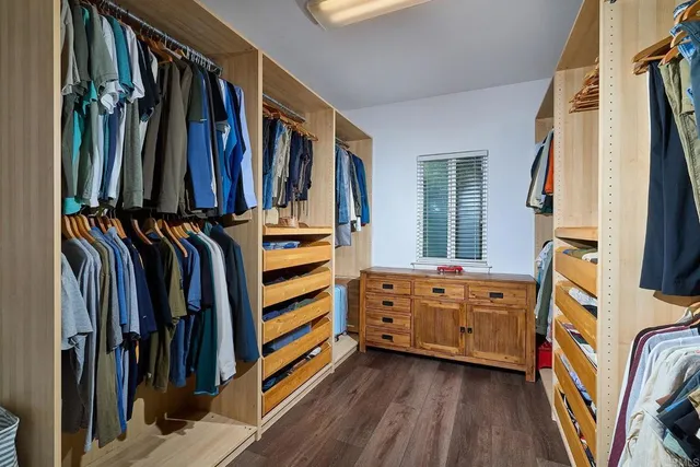 a bedroom with a bed and glass windows