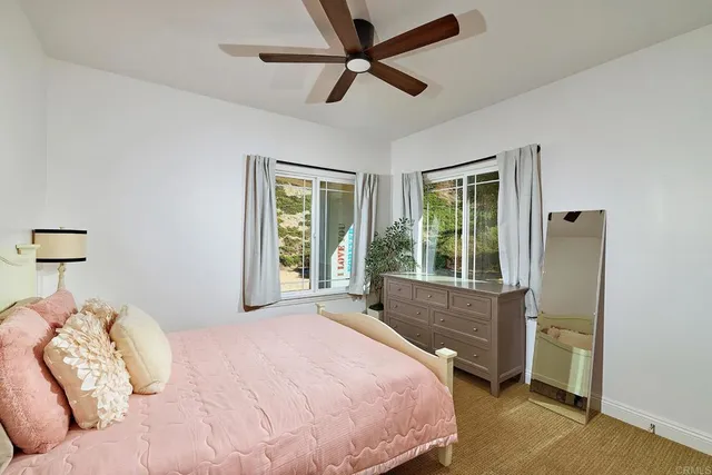 a bedroom with bed and a chandelier