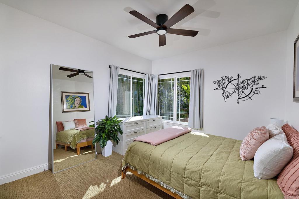 2869 Dos Lomas Place Fallbrook, CA 92028 - Photo 34 of 55 a bedroom with a bed and glass windows