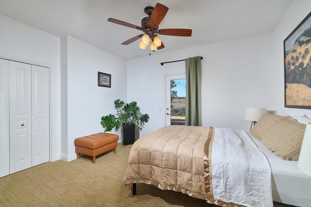 2869 Dos Lomas Place Fallbrook, CA 92028 - Photo 35 of 55 a bedroom with bed and a chandelier